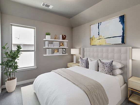 Secondary bedroom upstairs features plush carpet, neutral paint and a large window.