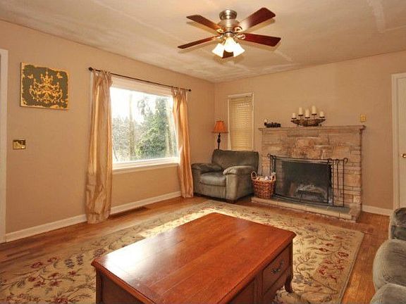 Charming living-room with real hardwood floors and a big picture window. Who could ask for anything more? Oh, a fireplace, this home as one of those as well.