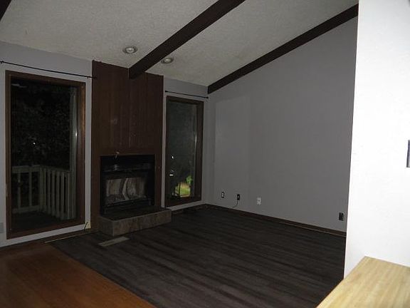Living Room with fireplace and balcony