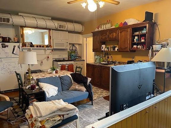 Open Plan Kitchen & LivingRoom shows Door to right rear past Kitchen Cabinets going to Laundry & Bath
