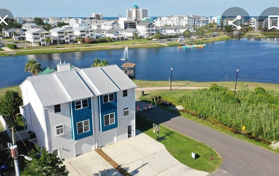 Left side of duplex. Lake front, 3 blocks from Beach. (Driftwood beach access). Fenced yard, metal roof. Room for 3 vehicles in driveway plus garage storage.