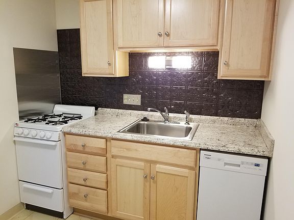 South Wall of Kitchen - New Maple Cabinets, Counter Top, Sink and Faucet, Dishwasher and Backsplash.