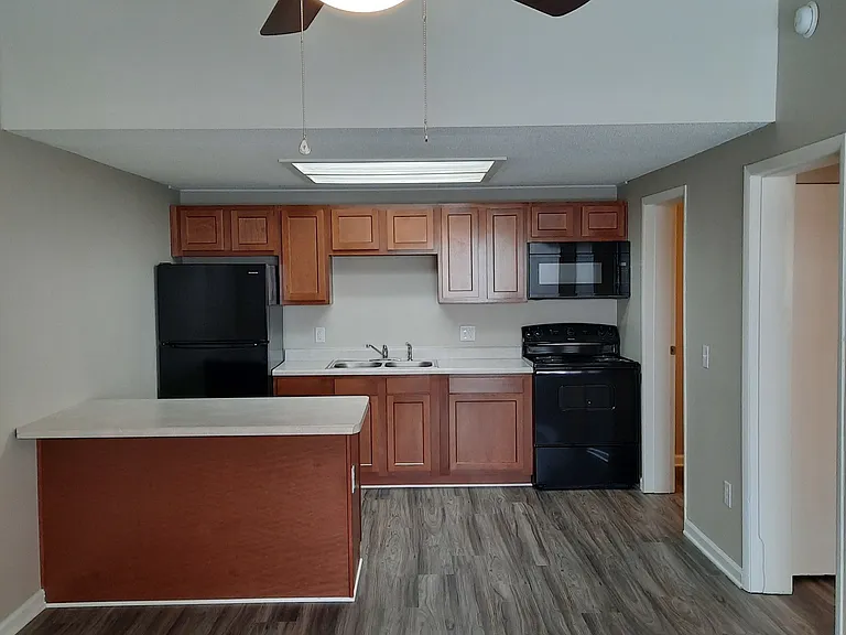 Hampton kitchen. Also showing is a ceiling fan with light in the open living room