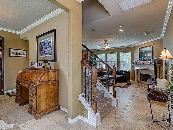 Upon entering the home, notice the gorgeous iron staircase.