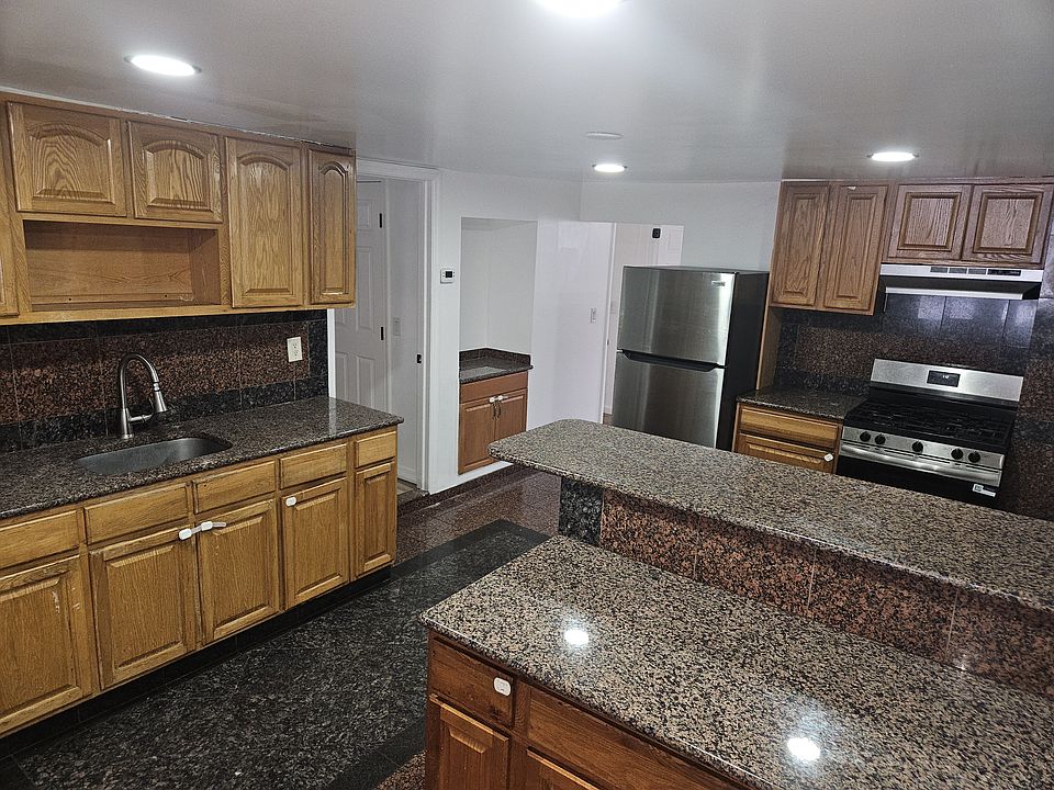 Kitchen with Granite countertops & Stainless Steel appliances.