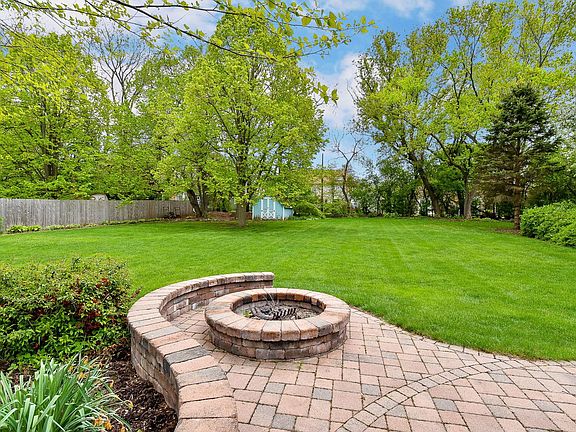 Large and private back yard with built-in fire pit.