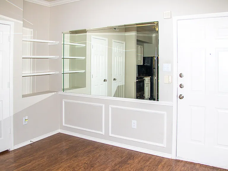 Living area featuring built-in shelving and accent wall details