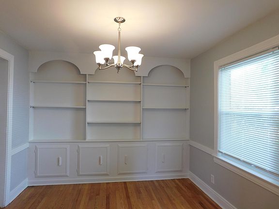 Dining room with built in shelves & cabinets. View from living room.