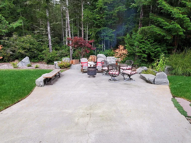 Backyard living at its finest in the Pacific Northwest. Large concrete patio, perfect for a campfire or hosting a gathering.