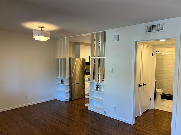 Photo captures dining, kitchen, and hall to new bathroom.