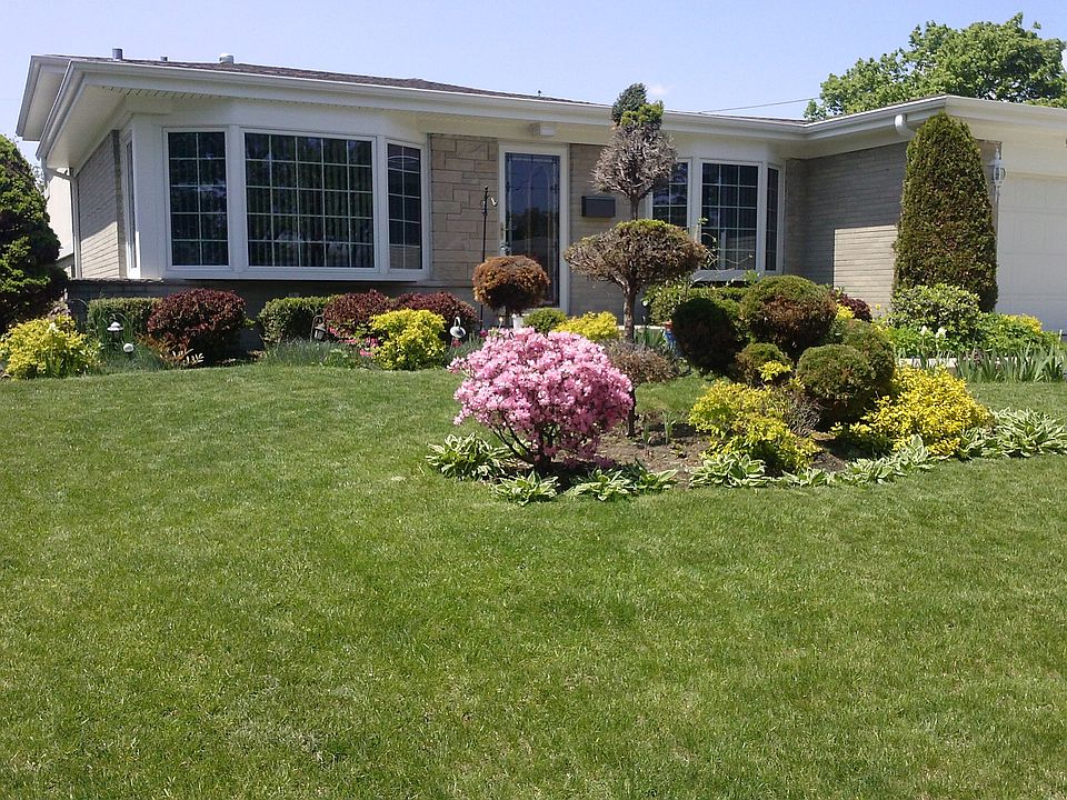 Front yard and front view of the house with bay windows