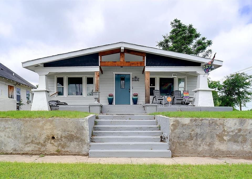 View of front of house featuring covered porch and stairs