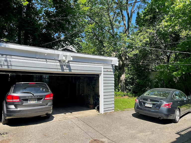 Garage, open parking area, and backyard