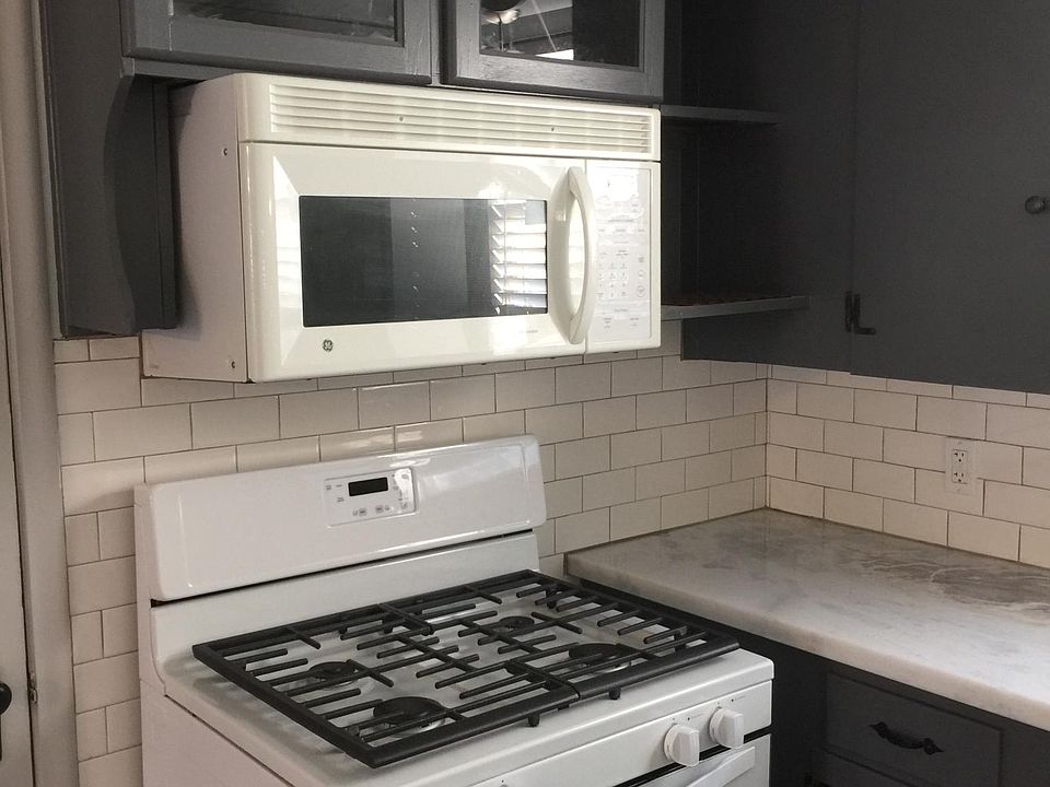 cooking and reclaimed cabinets above