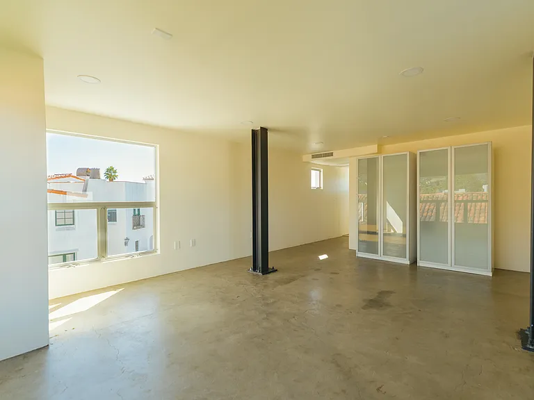 View of the second floor looking toward the bathroom and staircase to the first floor.