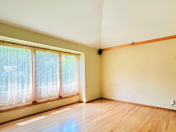 Living room with high ceiling and wood floor