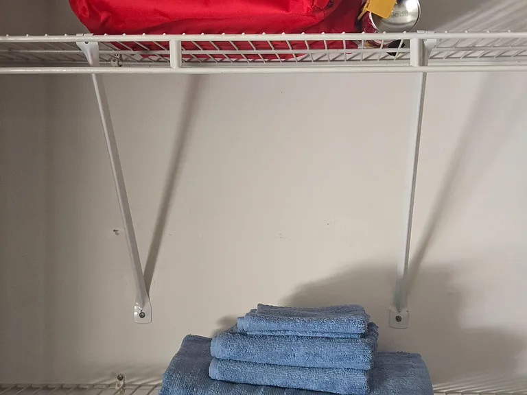 Convenient linen storage with durable wire shelving, ideal for towels and household essentials.