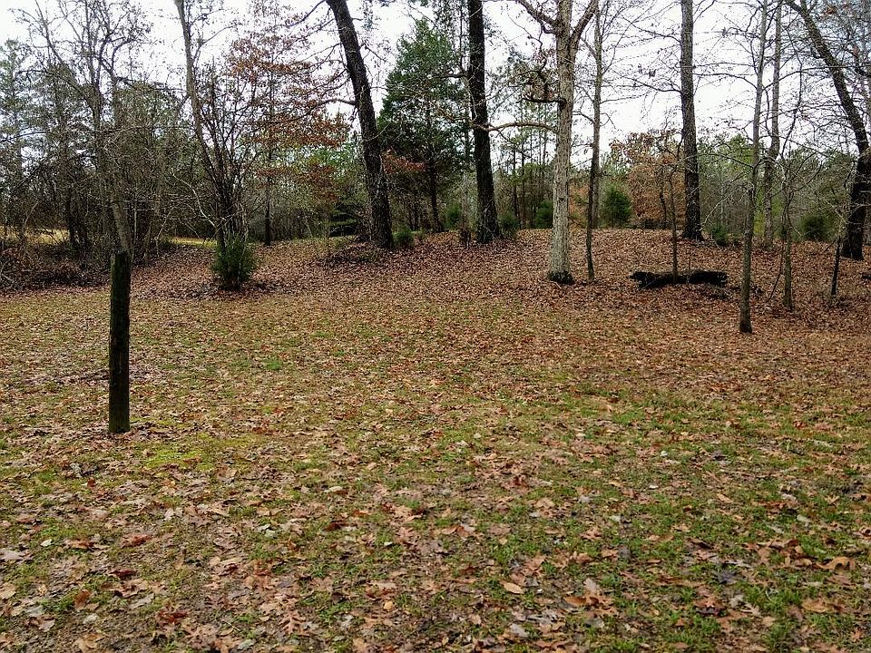 Behind house, about 2.4 acres go with house