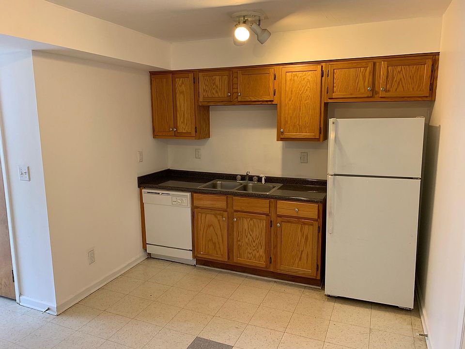 Spacious kitchen area that includes fridge,dishwasher ,and stove