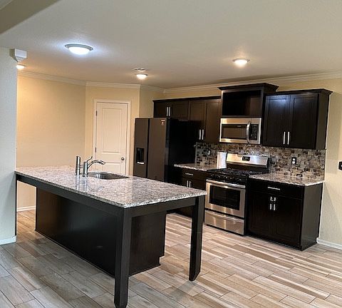 Large kitchen with granite counter tops and dining area
Refrigerator & Dishwasher