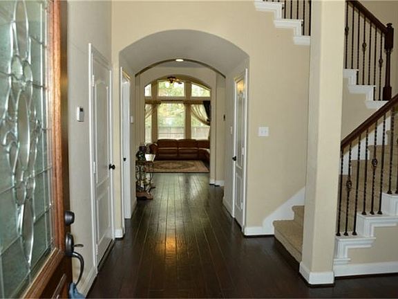 Entrance into this lovely Chesmar home displays beautiful hardwood floors