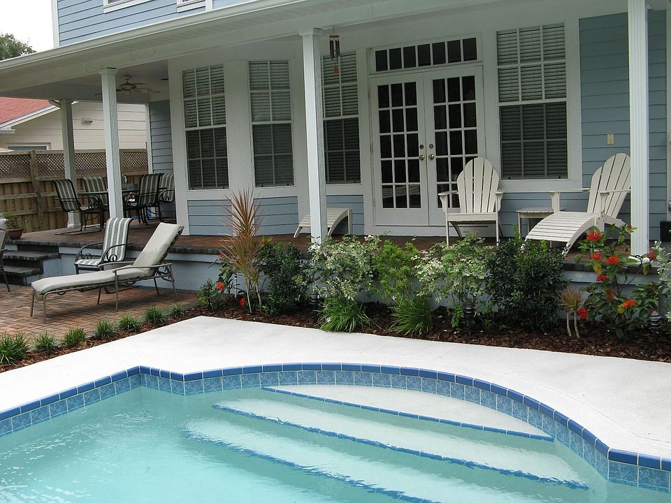 Relax on your covered back porch or brick-paver patio