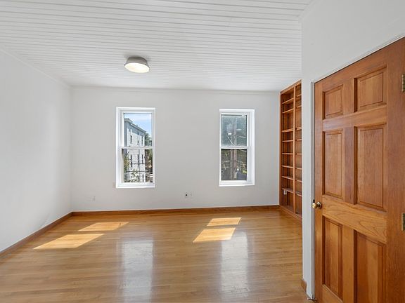 Living room with built in book case and mini split AC system