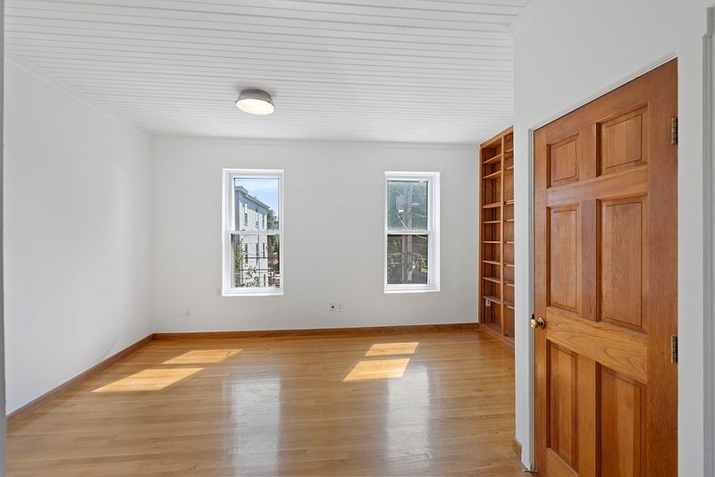 Living room with built in book case and mini split AC system
