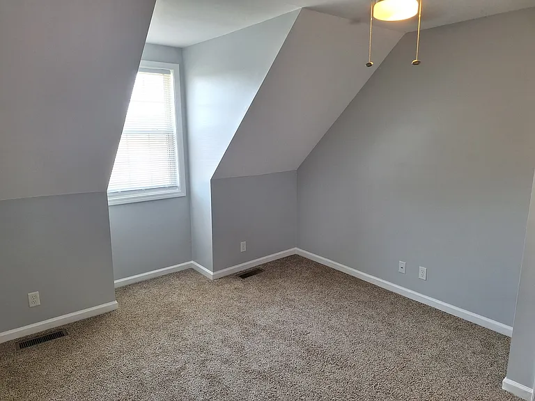 Bright upstairs bedroom #3 with large closet and ceiling fan.