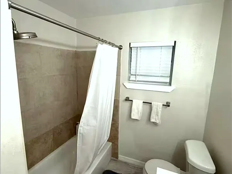 Clean, well-maintained bathroom with tub and shower