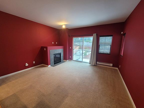 Living room with gas fireplace and deck