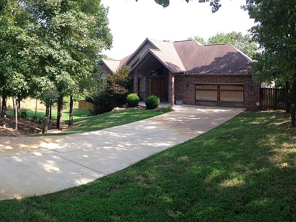 Large front yard with trees