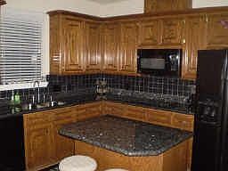 CUSTOM KITCHEN THAT IS A COOKS DREAM. HAS GRANITE COUNTERTOPS, TILE BACKSPLASH, 42' CABINTES, &amp; 