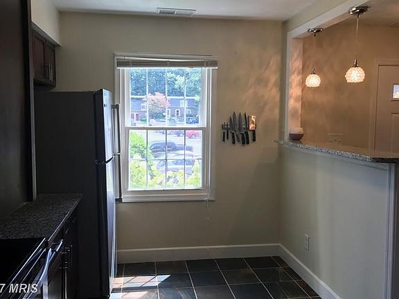 Kitchen with new refrigerator and window.