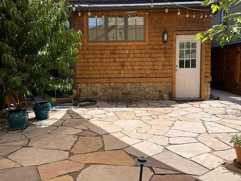 Backyard patio with shade sails and gazebo lights