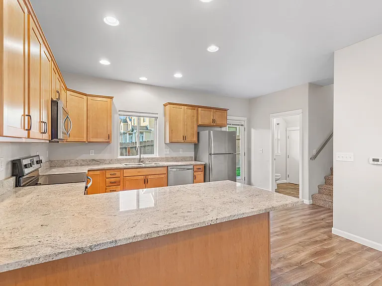 Kitchen with view of staircase and half bath