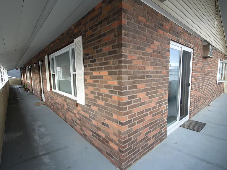Larger sliding glass doors and windows in main living area.