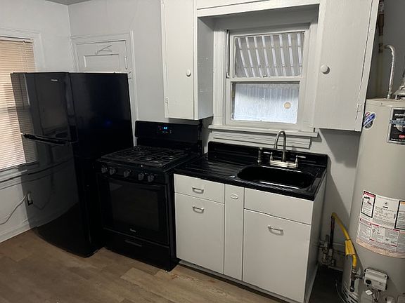 Kitchen - refrigerator, stove and sink.