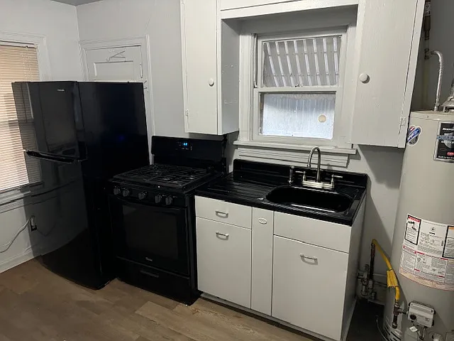Kitchen - refrigerator, stove and sink.