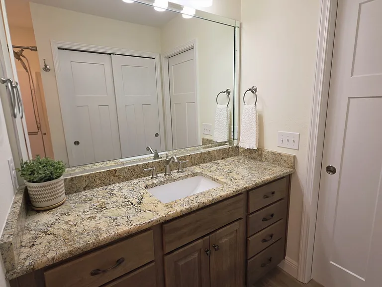 Hallway bathroom with large countertop and lots of drawers for storage
