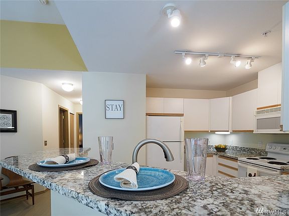 Oversized new granite counters and a large common area affords options of seating or hosting the neighbors for smorgasbord!