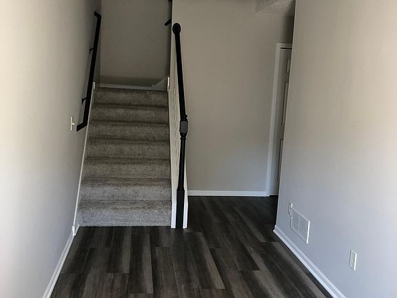 Entry way looking at staircase. Laundry/mechanical room with full size washer and dryer is around the corner to the right. Lots of under-stair storage.