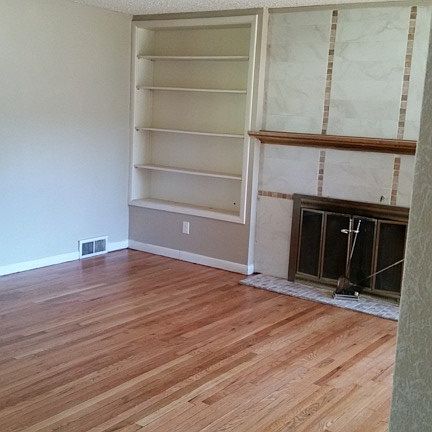 living room with wood burning fp