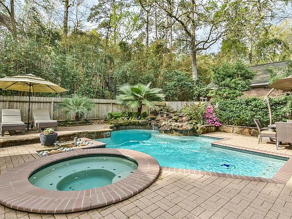 A beautiful outdoor living with Outdoor Paradise, Gorgeous pool/spa, and Rock waterfall