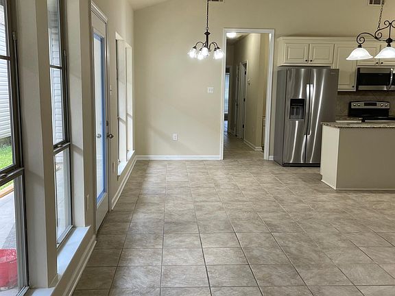Additional area perfect for dining -also shows entry to porch, deck and yard