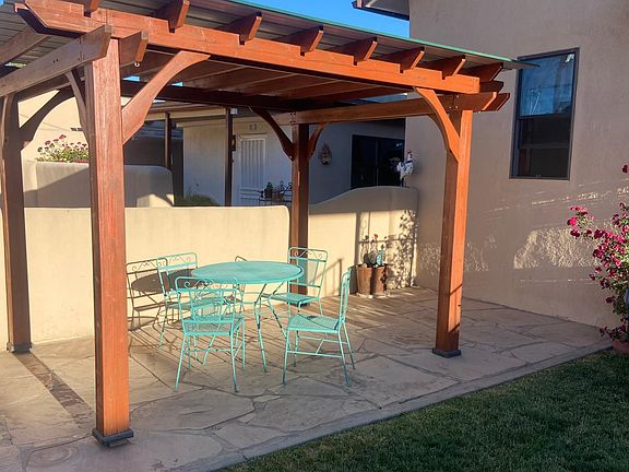 Covered red wood pergola, newly stained with outdoor patio table.