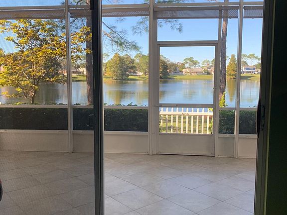 Screened in porch overlooking back yard and pond.