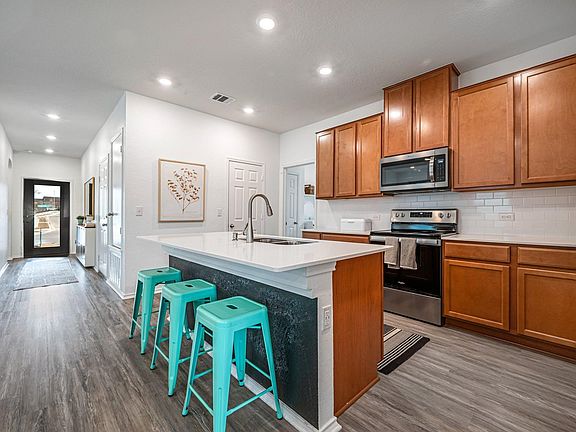 Spacious kitchen with ample space for preparing food and entertaining