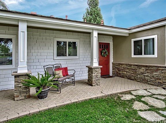 Pretty paver porch, stacked stone & detailed millwork!