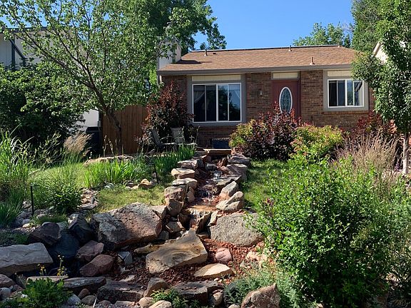 Front waterfall and manicured landscaping with automatic sprinklers, all yard maintenance provided